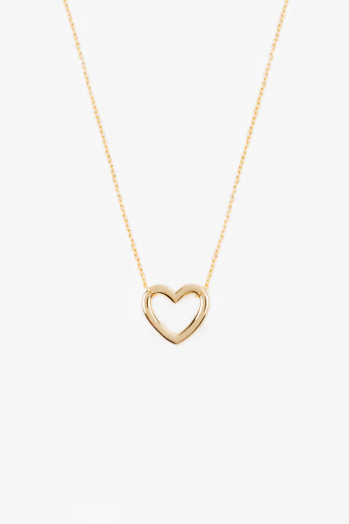 gold plated heart shaped pendant on a gold chain. necklace is on a white background